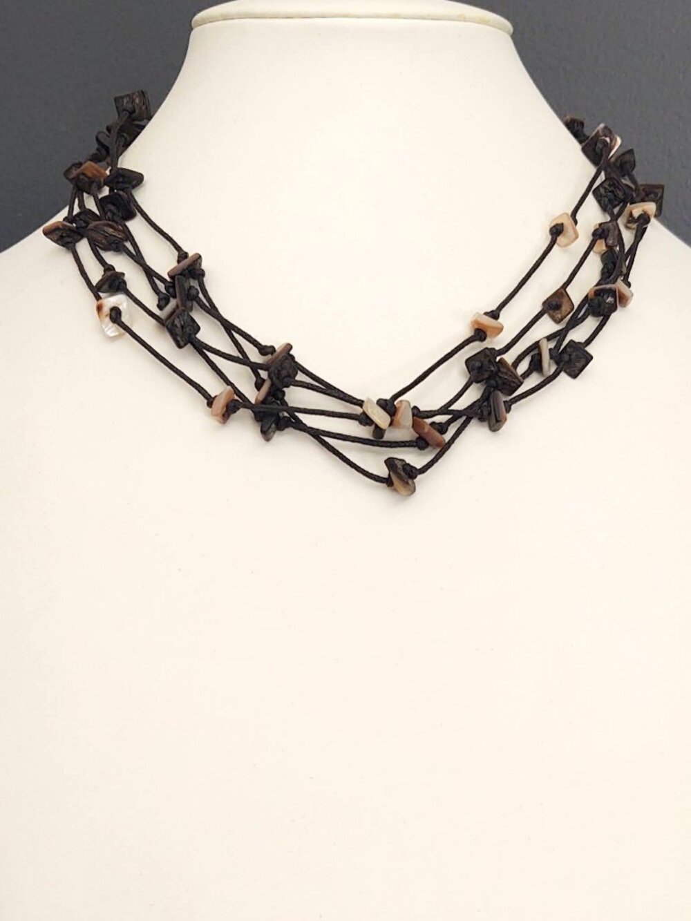 Layered corded necklace with shell pieces
